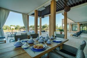 a wooden table with blue and white vases on it at L'Orientale By La Siredrah in Marrakesh