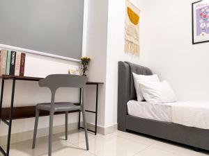 a bedroom with a desk and a chair next to a bed at Greenfield Residence Bandar Sunway in Petaling Jaya