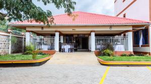 a house with a red roof and a patio at Grand Duke Hotel ,Homa Bay in Homa Bay