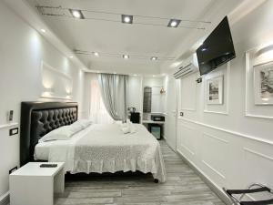 a bedroom with a bed and a flat screen tv at Locanda Parlamento in Rome