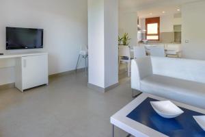sala de estar con sofá blanco y TV en Tossa dreams en Tossa de Mar
