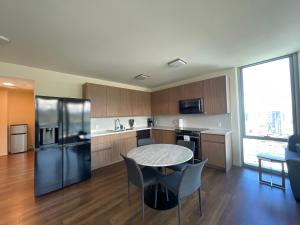 a kitchen with a table and chairs in a room at Semprose Central Ala Moana in Honolulu
