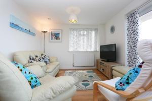 ein Wohnzimmer mit 2 Sofas und einem TV in der Unterkunft BOURNECOAST: FLAT with PANORAMIC SEA VIEWS- FM6180 in Bournemouth