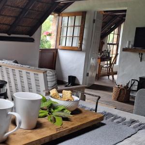 a table with a bowl of food on top of it at Prospect Farm Cottages in George