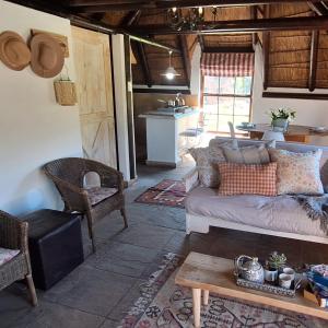 a living room with a couch and a table at Prospect Farm Cottages in George