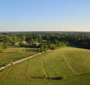 an aerial view of a field and a road at Klarysewo bliżej Słońca in Mrągowo