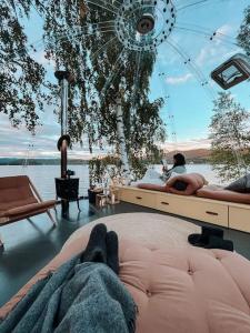 a person laying on a bed in a room at Specatular glass-igloo by the water! 