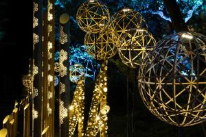 a bunch of lights hanging from a fence at night at The Prince Sakura Tower Tokyo, Autograph Collection in Tokyo