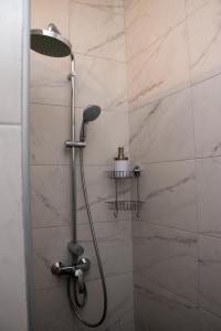 a shower with a shower head in a bathroom at 139,Triq Aristarku, St Paul's Bay in St Paul's Bay