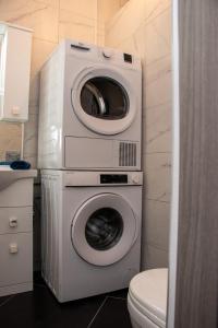 a washing machine and a dryer in a bathroom at 139,Triq Aristarku, St Paul's Bay in St Paul's Bay