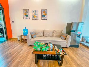 a living room with a couch and a refrigerator at Cerf Volant Soc Son in Sóc Sơn