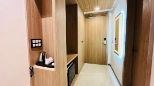 a small bathroom with wooden walls and a door at Hotel Aryavilas-A Luxury Boutique Hotel in Mathura