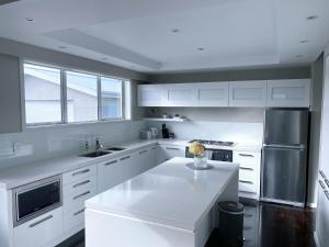 a kitchen with white cabinets and a white counter top at Prebbleton lifestyle Villa in Prebbleton