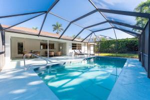 an indoor swimming pool with a retractable roof at Pesaro Vacation Rental in the Moorings in Naples