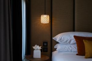 Postel nebo postele na pokoji v ubytování Deep Blu Boutique Hotel