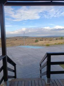 a view of an empty parking lot from a porch at Motel 112 in Algora