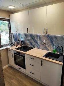 a kitchen with white cabinets and a sink at Holiday Home in Killarney in Killarney