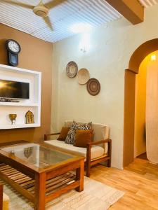 a living room with a couch and a coffee table at SAFARI in Stone Town