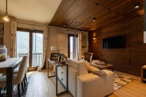 a living room with a couch and a table at Luxury Lodges by Grand Hotel Sitea in Sestriere