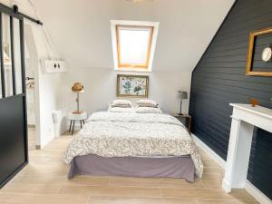 a bedroom with a large bed in a attic at Charmant studio paisible in Alençon