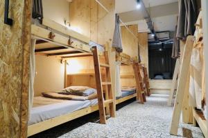 a group of bunk beds in a room at Walk Home Hostel in Chiayi City