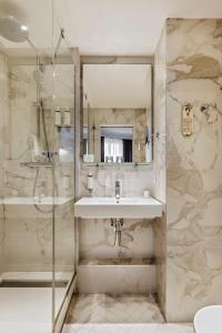 a bathroom with a sink and a shower at Maison Pigalle in Paris