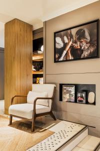 a living room with a chair and a fireplace at Maison Pigalle in Paris