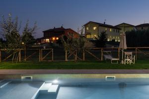 a swimming pool in a yard with a house at Incanto Toscano in Larciano
