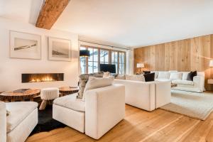 a living room with white furniture and a fireplace at Chalet Lilly - Luxury by A-Appartments in Zug