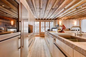 a kitchen with wooden ceilings and a wooden floor at Chalet Lilly - Luxury by A-Appartments in Zug