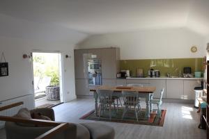 a kitchen and dining room with a table and chairs at Horsemans Barn in Kingsbridge