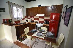 a kitchen with a table and a red refrigerator at Casa Frasta in Tzoumerka in Frásta