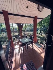 a screened in porch with a table and a bench at bungalow in Amphoe Koksamui