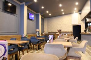 a restaurant with tables and chairs and a chalkboard on the wall at Cibali Hotel Istanbul in Istanbul