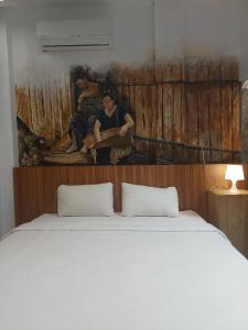 Ένα ή περισσότερα κρεβάτια σε δωμάτιο στο Ladja Hotel Sintang