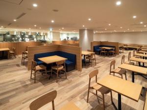 a restaurant with tables and chairs and a counter at 層雲閣 in Kamikawa