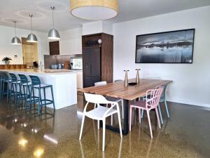 a kitchen with a wooden table and chairs at Hildeton Pool House in Shepparton