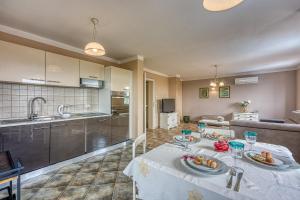 a kitchen and living room with a table with food on it at Villa Mare in Rovinj