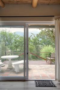 an open door to a patio with a table at Little Willow Brooke in Franschhoek