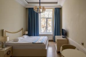 a hotel room with a bed and a window at Metro Hotel Apartments in Odesa