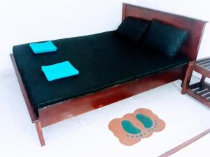 a model of a bed with a table and a chair at Black And White Kandy Guest House 01 in Kandy