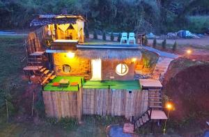 a small house in a field at night at ตั้วบ้านดิน Tuabaandin in Ban Thung Phan Ha