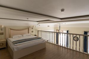 a bedroom with a bed and a balcony at Metro Hotel Apartments in Odesa +132 photos