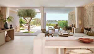 a living room with a couch and a table at Ikos Porto Petro in Portopetro