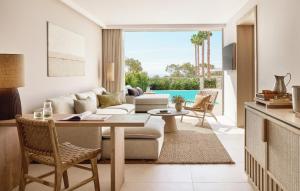 a living room with a couch and a table at Ikos Porto Petro in Portopetro