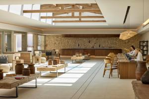 a rendering of a store lobby with tables and chairs at Ikos Porto Petro in Portopetro