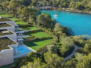 an aerial view of a house next to a body of water at Ikos Porto Petro in Portopetro