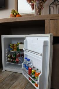an open refrigerator filled with lots of food and drinks at Cibali Hotel Istanbul in Istanbul
