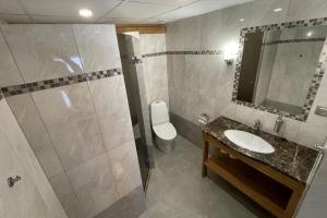 a bathroom with a shower and a sink and a toilet at Kütioru puhkekeskus in Koloreino +21 photos