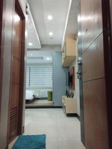 a hallway with a door and a room with a bed at Relaxing Studio at Morgan Suites walking distance Venice Piazza T219P in Manila